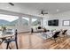 Bright living room featuring hardwood floors, modern furniture, and expansive windows with picturesque mountain views at 265 Upper Glenway, Palmer Lake, CO 80133