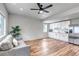 Open-concept living space with wood floors, modern lighting, and stylish gray sofa at 265 Upper Glenway, Palmer Lake, CO 80133