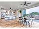 Spacious living room, dining room and kitchen with barstool seating and scenic views from the sliding glass doors at 265 Upper Glenway, Palmer Lake, CO 80133