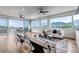 Bright living room featuring hardwood floors, modern furniture, and expansive windows with picturesque mountain views at 265 Upper Glenway, Palmer Lake, CO 80133
