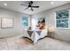 Comfortable main bedroom features a ceiling fan and natural light from two windows at 265 Upper Glenway, Palmer Lake, CO 80133