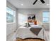 Light-filled main bedroom featuring two windows and modern decor at 265 Upper Glenway, Palmer Lake, CO 80133