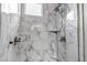 Modern shower featuring elegant marble tiles and sleek fixtures at 265 Upper Glenway, Palmer Lake, CO 80133