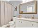 This bathroom features a white vanity, a large mirror, and a shower with a curtain at 10546 Graymont Ln # D, Highlands Ranch, CO 80126