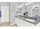 Bathroom featuring a dual sink vanity, a mirror, and a light grey color palette at 10546 Graymont Ln # D, Highlands Ranch, CO 80126