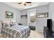 This bedroom has a ceiling fan, a window, and neutral walls at 10546 Graymont Ln # D, Highlands Ranch, CO 80126