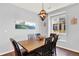 This dining room features wood floors, a table and chairs, and a large window at 10546 Graymont Ln # D, Highlands Ranch, CO 80126
