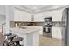 A kitchen with white cabinets, stainless steel appliances, and a tiled backsplash at 10546 Graymont Ln # D, Highlands Ranch, CO 80126