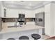 Modern kitchen featuring white cabinets, stainless steel appliances, and a quartz countertop island at 10546 Graymont Ln # D, Highlands Ranch, CO 80126