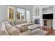 Comfortable living room with plush seating, a fireplace, and abundant natural light from large windows at 10546 Graymont Ln # D, Highlands Ranch, CO 80126