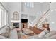 Bright and airy living room featuring a fireplace, large windows, and an open staircase at 10546 Graymont Ln # D, Highlands Ranch, CO 80126