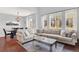 Open-concept living area with a comfortable sectional, dining space, and ample natural light at 10546 Graymont Ln # D, Highlands Ranch, CO 80126