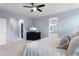 Bright main bedroom featuring an ensuite bathroom, walk-in closet, and a TV on a dresser at 10546 Graymont Ln # D, Highlands Ranch, CO 80126