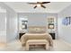 Cozy main bedroom boasts neutral tones, plush bedding, and abundant natural light from dual windows at 10546 Graymont Ln # D, Highlands Ranch, CO 80126