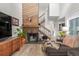 Inviting living room features a brick fireplace, wooden accents, and an open staircase at 1980 Joslyn Pl, Boulder, CO 80304