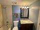 Bathroom features a shower-tub combination, granite top vanity and a framed mirror at 2929 W Floyd Ave # 217, Denver, CO 80236