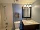 Bathroom features a shower-tub combination, granite top vanity and a framed mirror at 2929 W Floyd Ave # 217, Denver, CO 80236