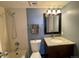 Bathroom features a shower-tub combination, granite top vanity and a framed mirror at 2929 W Floyd Ave # 217, Denver, CO 80236