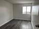 Bright bedroom with hardwood floors and a window with outside views at 2929 W Floyd Ave # 217, Denver, CO 80236