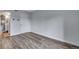 A bright bedroom featuring wood floors, a neutral wall color, and access to an ensuite bathroom at 2929 W Floyd Ave # 217, Denver, CO 80236