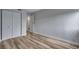 This bedroom features wood floors, neutral wall color, a closet and access to an ensuite bathroom at 2929 W Floyd Ave # 217, Denver, CO 80236