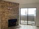 A stone fireplace and sliding door highlight the cozy living room at 2929 W Floyd Ave # 217, Denver, CO 80236