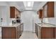Galley kitchen featuring stainless steel appliances, granite countertops and wood cabinets at 2929 W Floyd Ave # 217, Denver, CO 80236