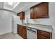 Updated kitchen featuring stainless steel dishwasher, granite countertops, and wood cabinets at 2929 W Floyd Ave # 217, Denver, CO 80236