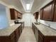 Well-lit kitchen with granite countertops, tile floors and stainless steel appliances at 2929 W Floyd Ave # 217, Denver, CO 80236