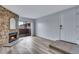 Cozy living room showcasing a stone fireplace and direct access to an outdoor balcony at 2929 W Floyd Ave # 217, Denver, CO 80236