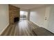 A stone fireplace and sliding door for natural light highlight the living room at 2929 W Floyd Ave # 217, Denver, CO 80236