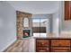 Inviting living room featuring a stone fireplace and sliding glass doors to outdoor living space at 2929 W Floyd Ave # 217, Denver, CO 80236