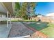 A beautiful backyard featuring a lawn, mature trees, and a fire pit at 4249 S Biscay Cir, Aurora, CO 80013