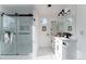 Contemporary bathroom featuring a glass-enclosed shower with marble tile and double sinks with modern fixtures at 4249 S Biscay Cir, Aurora, CO 80013