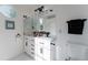 Sleek bathroom featuring double sinks, modern fixtures, a toilet, and an octagonal window at 4249 S Biscay Cir, Aurora, CO 80013