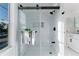 Bright bathroom showcasing a glass shower with white marble tiles and a built-in shower niche at 4249 S Biscay Cir, Aurora, CO 80013