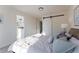 Bright bedroom boasts a sliding barn door, soft carpet, and a comfortable bed with plush bedding at 4249 S Biscay Cir, Aurora, CO 80013
