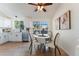 Bright dining area with large window and modern lighting fixture at 4249 S Biscay Cir, Aurora, CO 80013