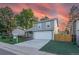 Charming two-story home with a well-manicured lawn and an attached two-car garage at 4249 S Biscay Cir, Aurora, CO 80013