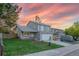 Two-story home with an attached garage, a landscaped yard and a charming brick garden at 4249 S Biscay Cir, Aurora, CO 80013