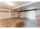 A spacious empty garage with a white door at 4249 S Biscay Cir, Aurora, CO 80013