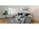Bright living room featuring modern decor, hardwood floors, and large bright windows at 4249 S Biscay Cir, Aurora, CO 80013