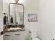 Well-lit powder room with marble countertop and rectangular black framed mirror at 581 Fairview Blvd, Breckenridge, CO 80424
