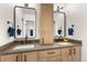 Bathroom featuring double sinks, stylish mirrors, and ample cabinet space for storage at 581 Fairview Blvd, Breckenridge, CO 80424