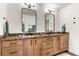 Bathroom vanity with wood cabinets, granite countertops and rectangular black framed mirrors at 581 Fairview Blvd, Breckenridge, CO 80424