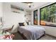 Bright bedroom featuring a large window, comfortable bed, and shelving for decor and storage at 581 Fairview Blvd, Breckenridge, CO 80424