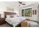 Cozy bedroom with a large bed, modern ceiling fan, and a scenic view of the trees at 581 Fairview Blvd, Breckenridge, CO 80424