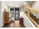Welcoming foyer with hardwood floors, wooden staircase, and mountain views through the front door at 581 Fairview Blvd, Breckenridge, CO 80424