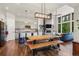 Open-concept living room with large windows, a fireplace, and an adjacent dining area with a wooden table at 581 Fairview Blvd, Breckenridge, CO 80424