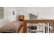 Comfortable loft with desk area and lower-level view with wood railing and modern black wire at 581 Fairview Blvd, Breckenridge, CO 80424
